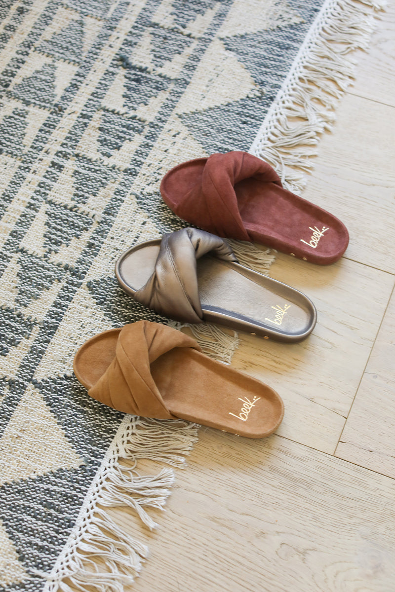 Group shot of Tesia slide sandal in almond suede, mocha leather, fig suede.