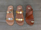 Group shot of Topaz leather slide sandals in beach, honey with Goldfinch leather toe-ring sandals in tan.