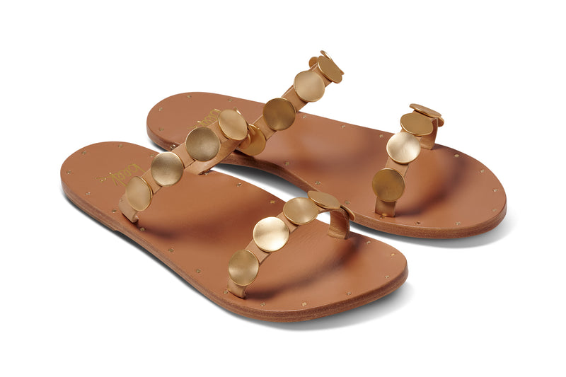Topaz leather slide sandals in honey with gold accents - product angle shot