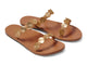 Topaz leather slide sandals in honey with gold accents - product angle shot