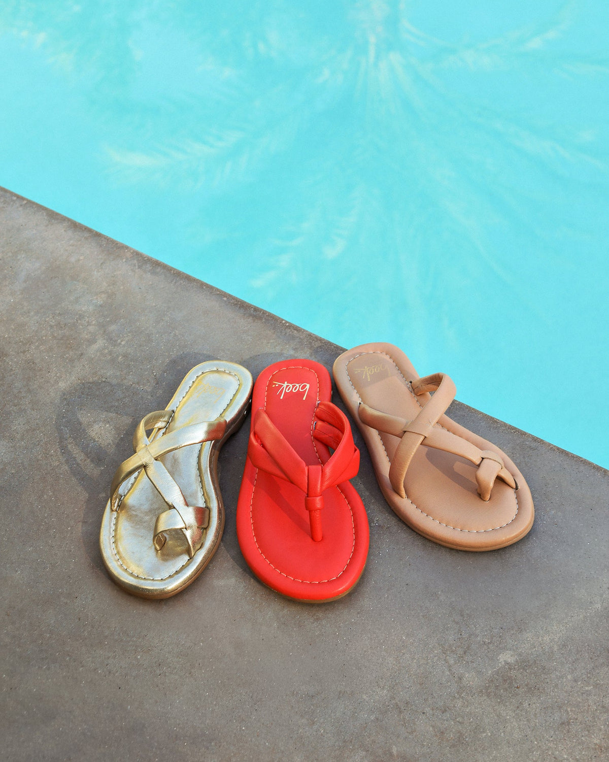 Group shot of Toucan leather sandals in tomato with Sungem in gold and beach