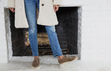 Woman wearing Towhee suede shoe in leopard with jeans and white coat.