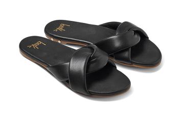Twistybird leather slide sandal in black - angle shot