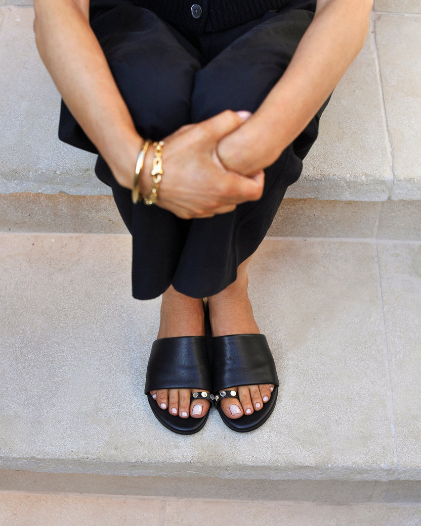Woman wearing Vireo leather toe-ring sandal in black with black pants
