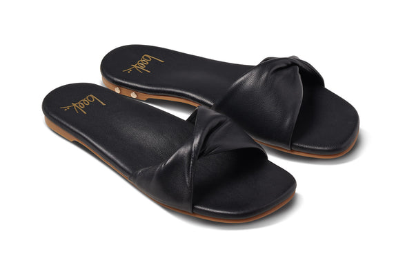 Whipbird leather slide sandal in black - angle shot