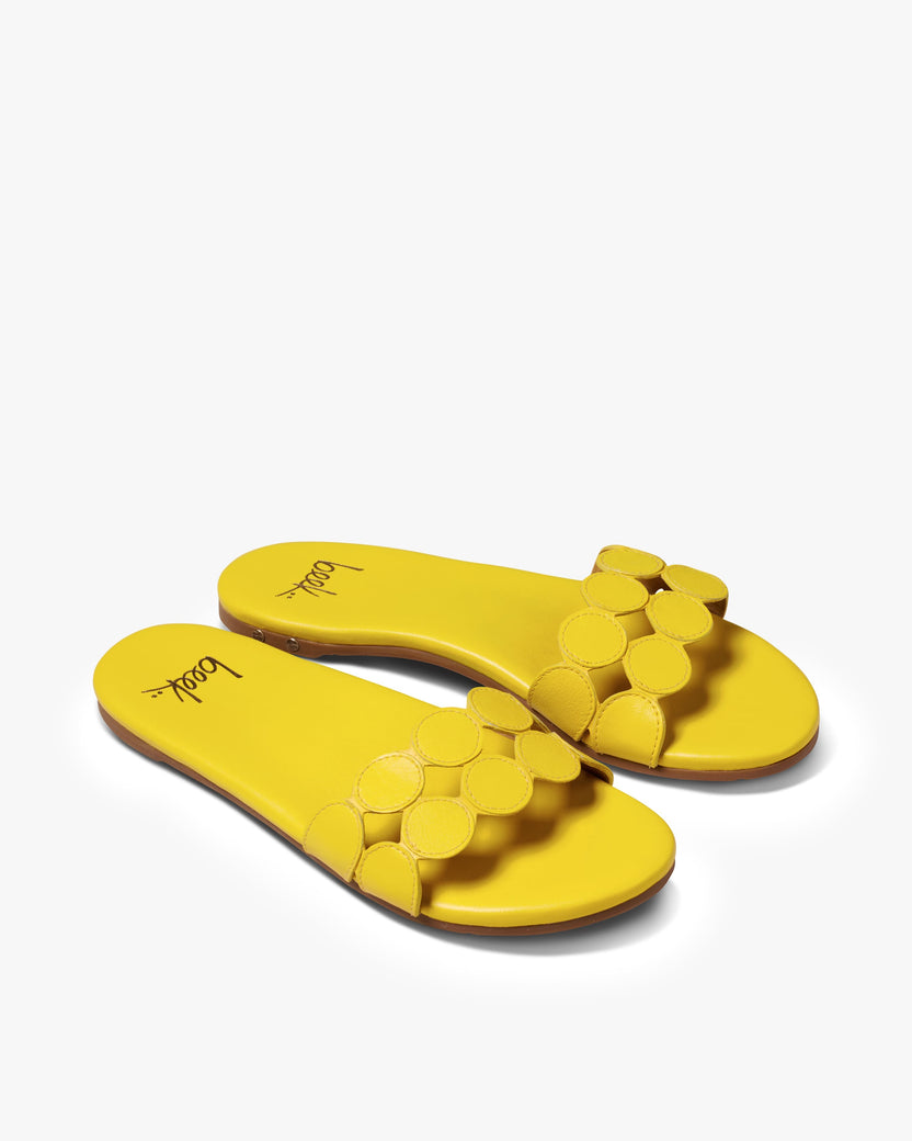 Whirlybird leather slide sandals in lemon - product angle shot