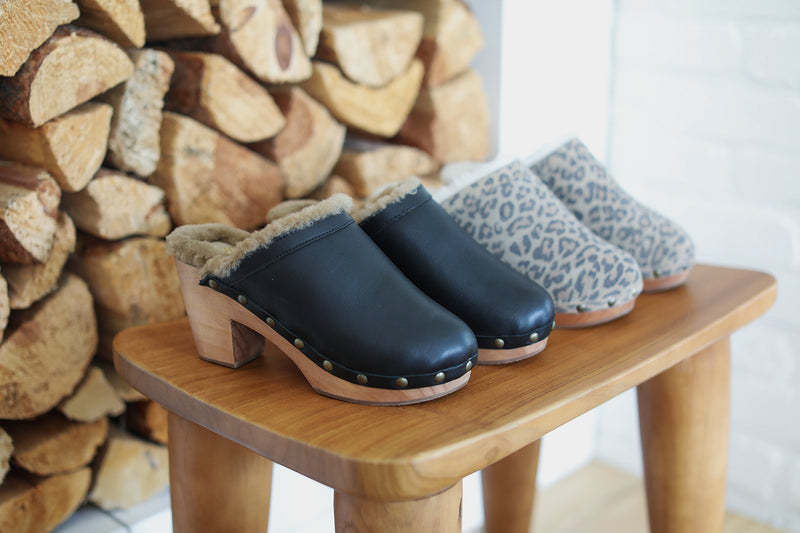 Woodpecker Shearling clogs in black leather and leopard suede.