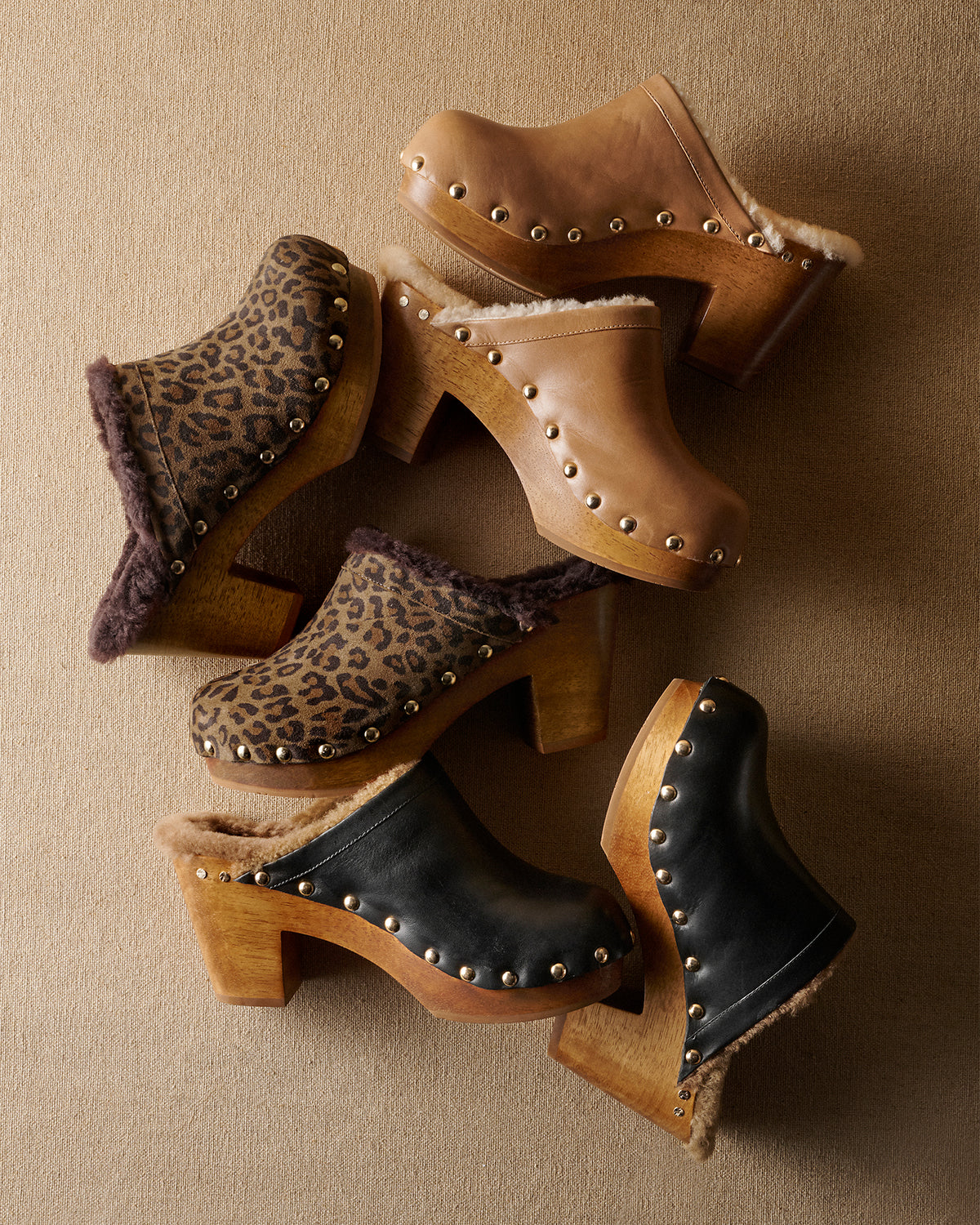 Group shot of Woodpecker Shearling clogs in saddle leather, leopard suede, black leather