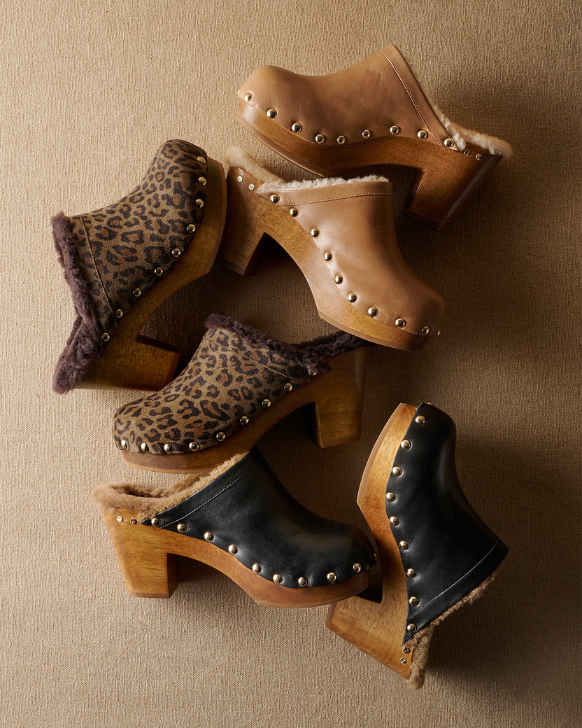 Group shot of Woodpecker Shearling clogs in saddle leather, leopard suede, black leather