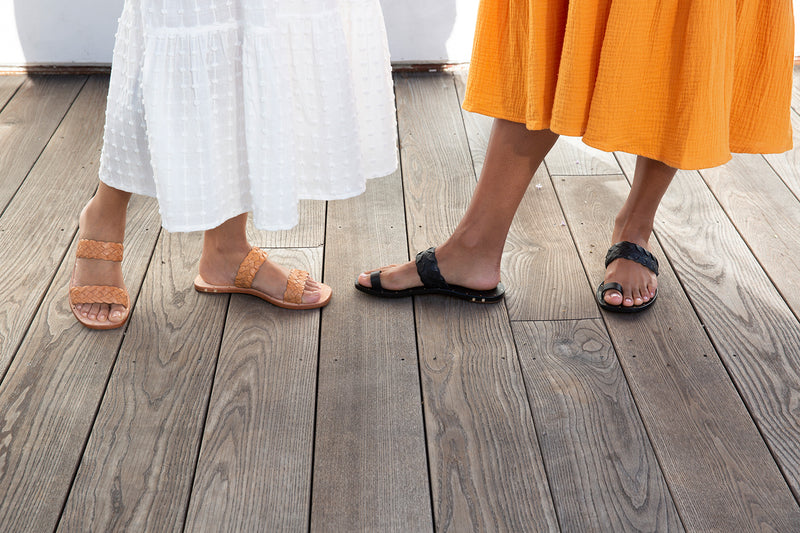 Women wearing Cockatoo leather toe ring sandal in black and Cockatiel slide sandal in honey