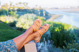 Woman wearing Cockatiel leather slide sandal in honey
