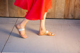Woman wearing Cockatoo leather toe ring sandal in platinum/beach 