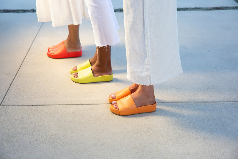 Women wearing Pelican platform sandal in papaya, celery, flamingo