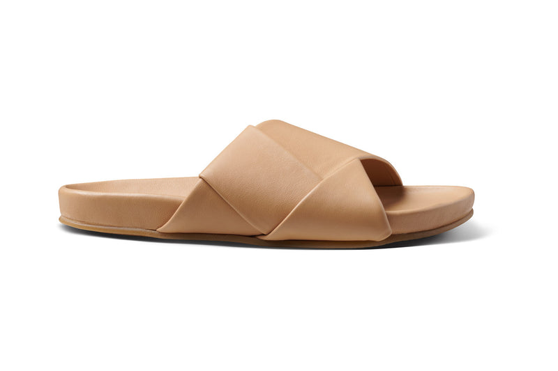 Tori leather slide sandal in beach - product outside shot