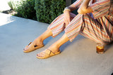 Woman wearing Tori leather slide sandal in beach