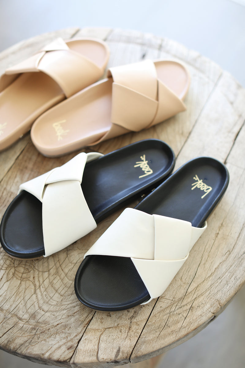 Tori leather slide sandal group product shot in beach and eggshell/black